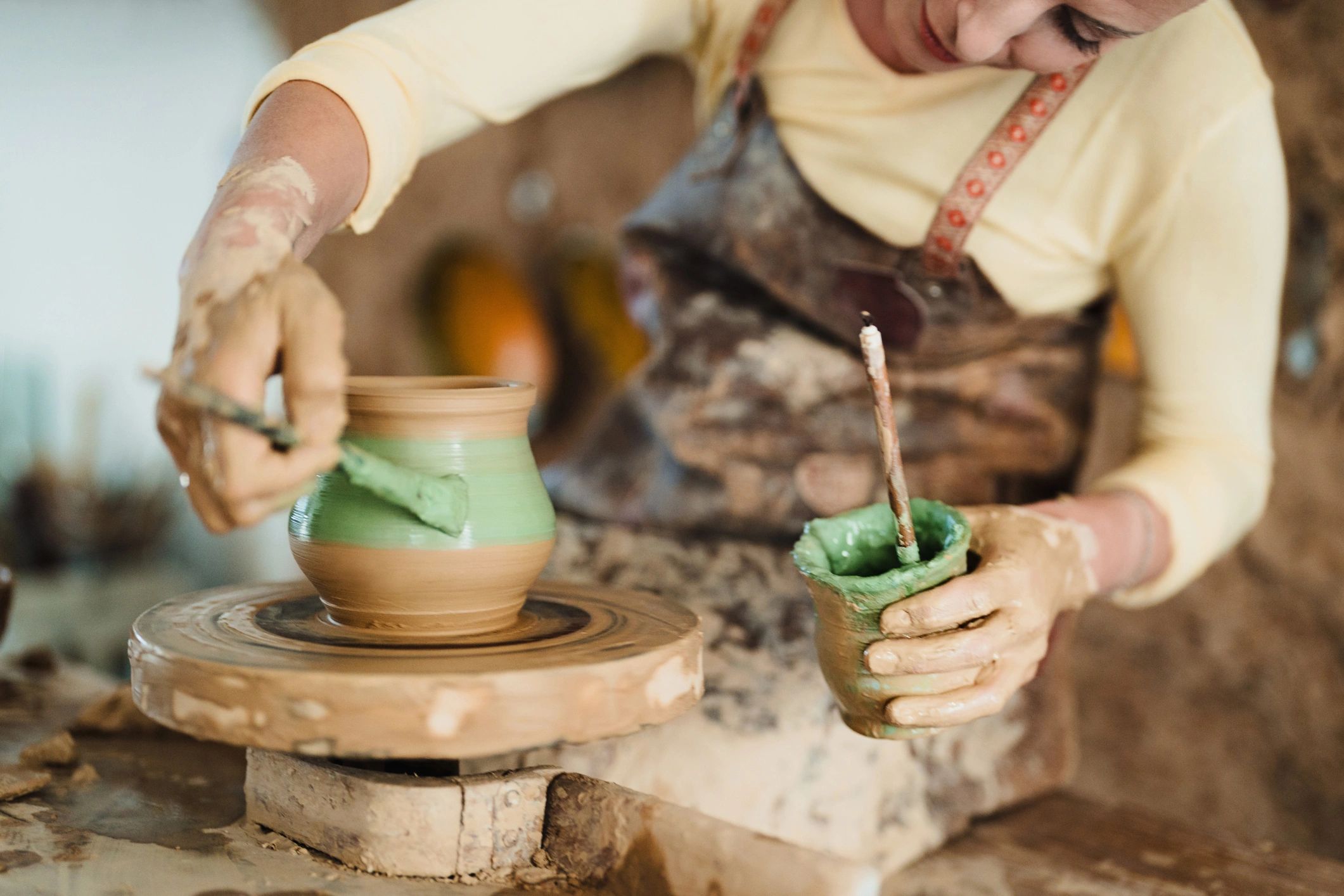 Artisan working with clay in a pottery studio